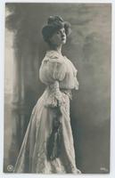 [Woman posed in ruffled dress with feather fan] 988/3