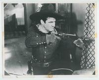 [Tom Mix shooting two guns from "Terror Trail"