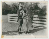 [Tom Mix protects Lady co-star]