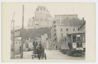 [Street scene with horse-drawn cart and streetcar]