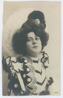 [Woman posed in elaborate dress and hat] 550