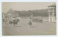 [Cowboys on horseback riding in parade in an arena with Native Americans]