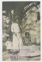 [Indian snake charmer with two children]