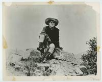 [Tom Mix atop mountain]