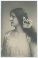[Pensive woman posed in lace camisole with a flower in her hair]