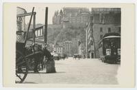 [Street scene with horse-drawn cart and streetcar]