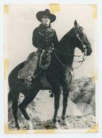 [Posed portrait of Mix in Black Hat and Mix Astride Horse]