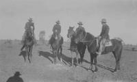 [4 cowboys on horseback]