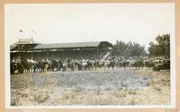 [photograph of a group of cowboys and cowgirls in the middle of an arena