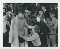 [Tom Mix playing part as a boxer talks to young boy]