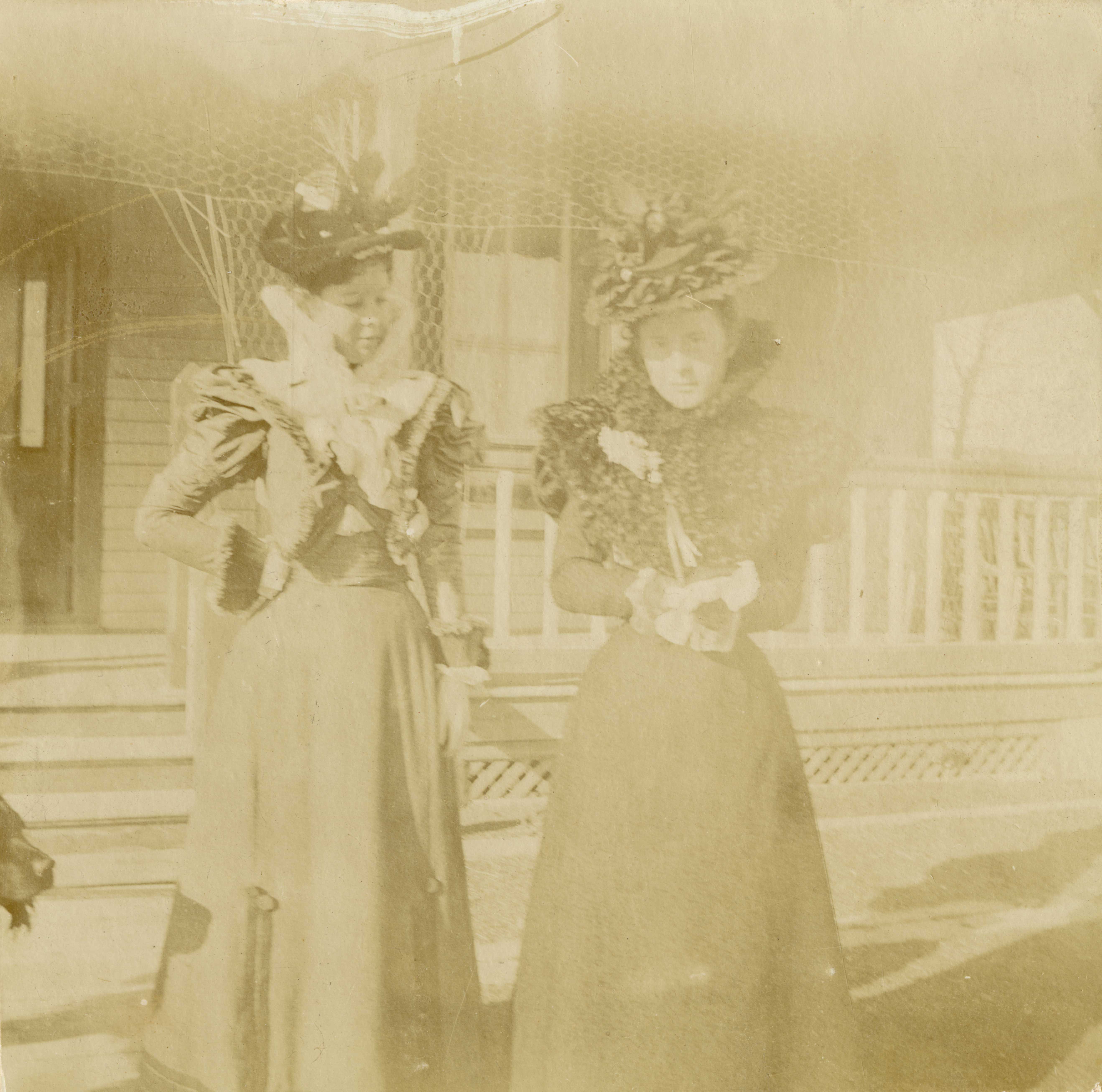 [Isabel Hamilton with one of her daughters in front of the family home at Fort Robinson]