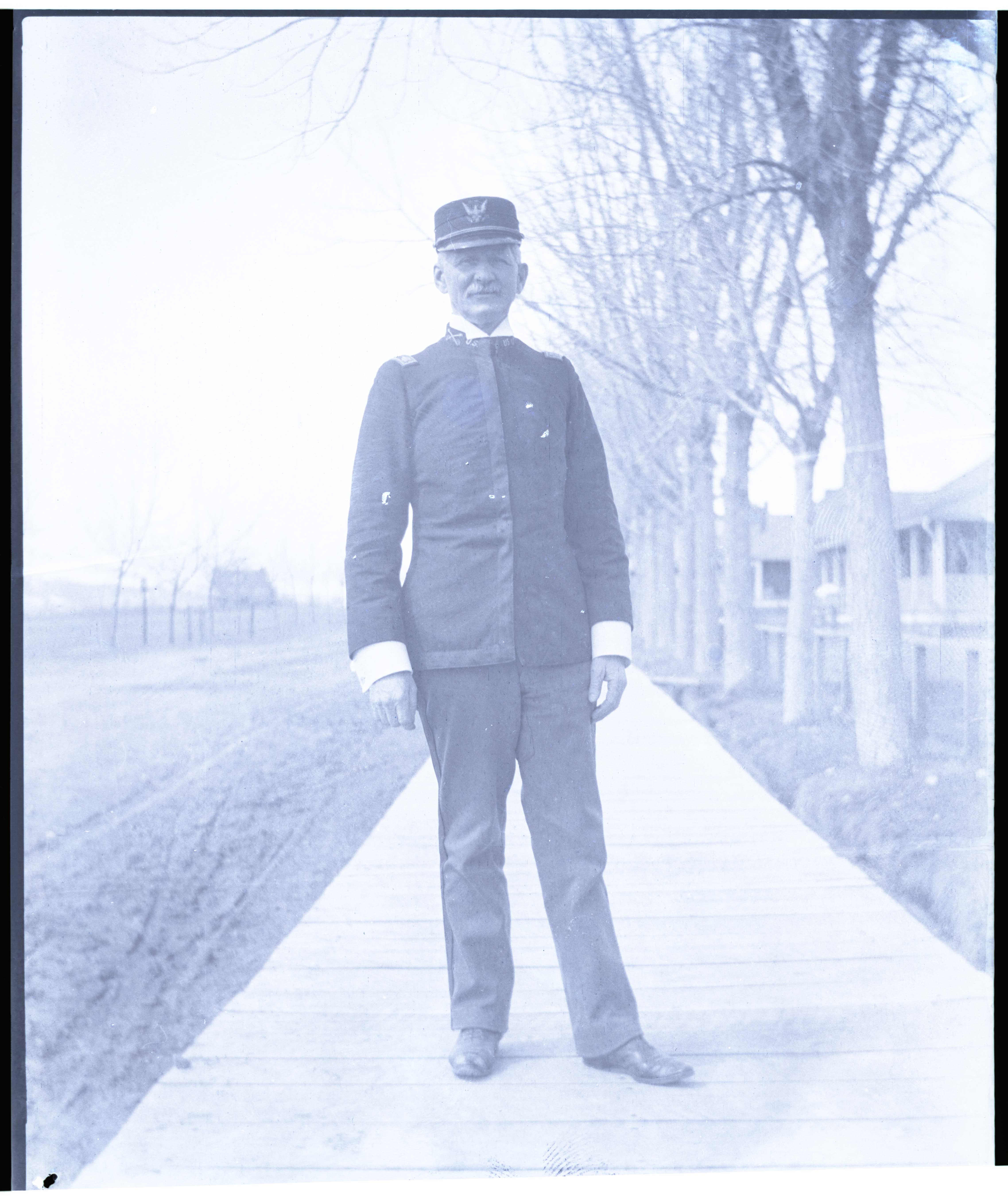 [Full-length portrait of Lt. Colonel John M. Hamilton on the boardwalk at Fort Robinson, Nebraska]