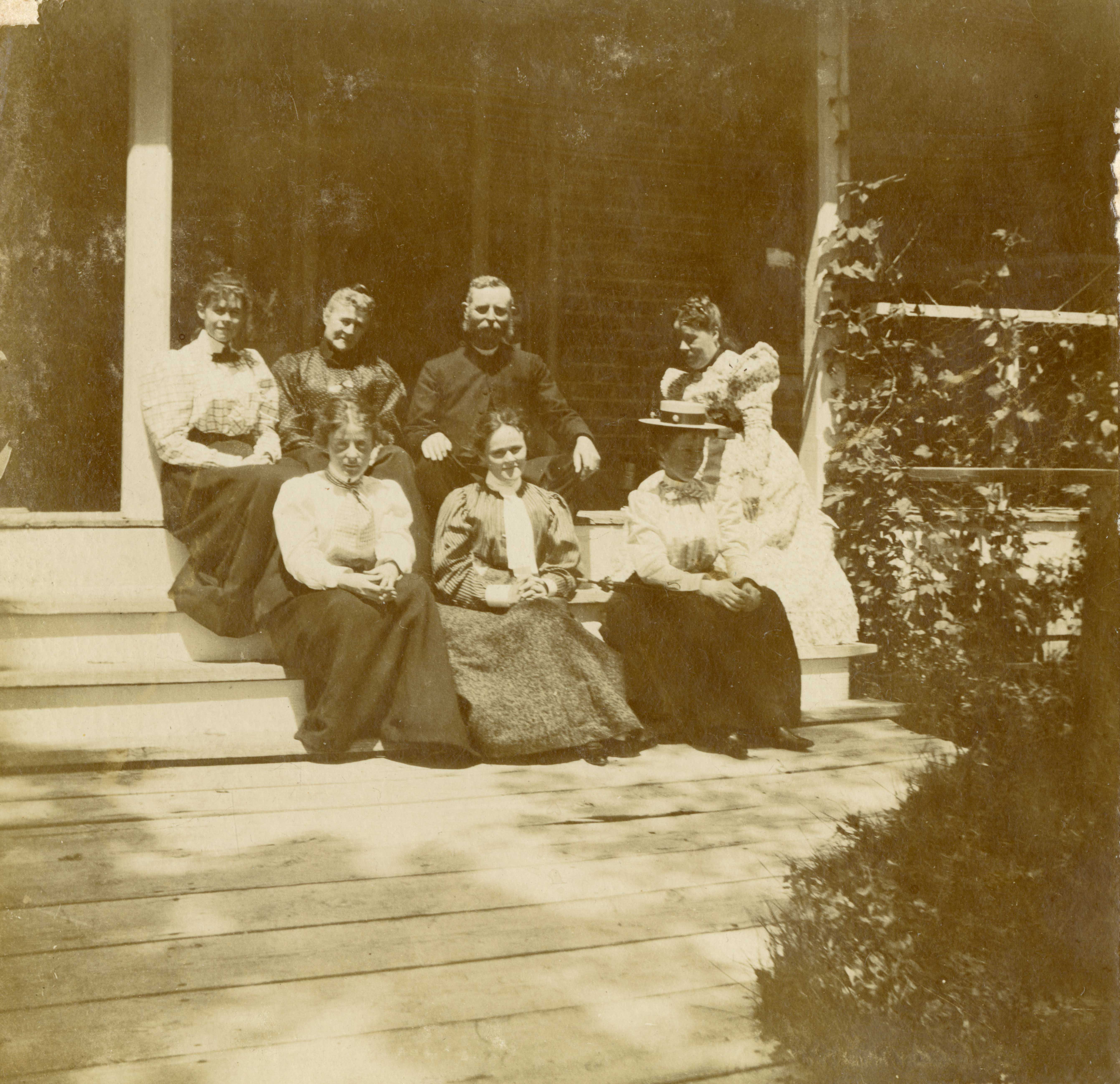 [Lt. Colonel and Isabel Hamilton with daughters and others on  front steps of their house]