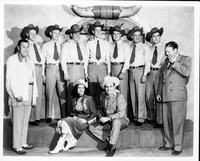 Bob Wills and the Texas Playboys [posing with a cowgirl]