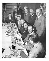 Tulsa, Okla [Group photo of Foghorn Clancy, 8 men, 1 woman at a banquet]