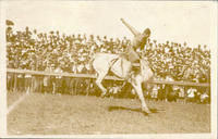 [Cowboys saddle bronc riding]