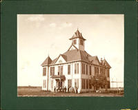 [Group of men standing in front large building with cupola]