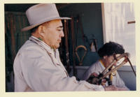 [Luis Ortega and wife working in shop]