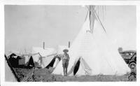 July 1928 EWR in front of Mrs. Arnold's teepee at Lodge Grass. Afterward put up at Quarter Circle U R