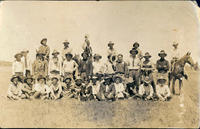 [Large group of cowboys posing for a photograph]