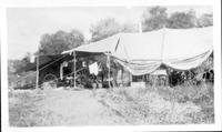 July 1928 Chuck Wagon + Cook's tent Lodge Grass Camp; Anna rolling biscuits