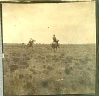 [Two Cowboys riding on horses]