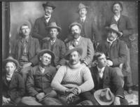 [10 men and a boy posing for a photograph]