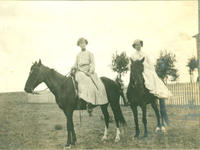 [Two well-dressed women each on horseback]