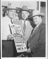 [Foghorn Clancy and 2 other men holding a rodeo poster]