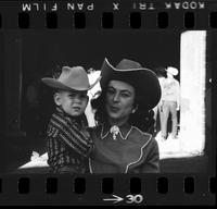 [Portrait of unknown cowgirl and young boy]