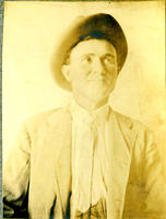 [Medium studio shot of cowboy in suit and tie]