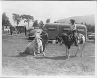 Smoky Hinkson shows cowgirl Loraine Yale how he trained his Brahma Bull "White Eagle"