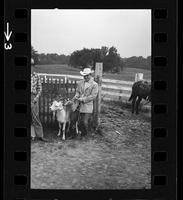 [Unknown cowboy with calf]
