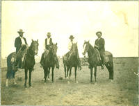 [Four well-dressed cowboys on horseback]
