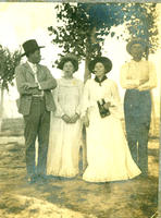 [2 men and 2 women standing side by side all smoking cigars while one woman holds binoculars]