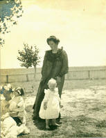 [Two well-dressed women with Children outdoors]