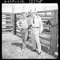 John Van Cronkhite and Deb standing by corral