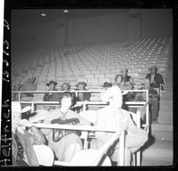 Cowboys sitting in stands