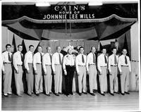 Johnnie Lee Wills and band [band is posing in front of stage at Cain's]
