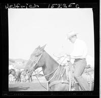Tom Nesmith (Pose)  sitting on horse with rope