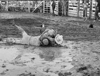 Rodeo clowns and riders in the Mud