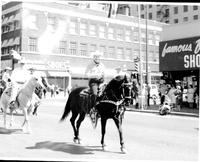 [Johnnie Lee Wills on horseback in a parade]