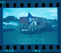 Unidentified Cowgirl on horse with flag
