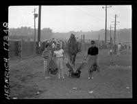 3 Women carrying gear after rodeo