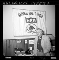 John Van Cronkhite standing in front of NFR sign