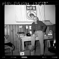 John Van Cronkhite Sitting on desk NFR sign in background